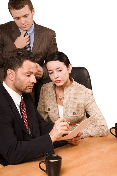 istock three people reading report at the desk 96397159