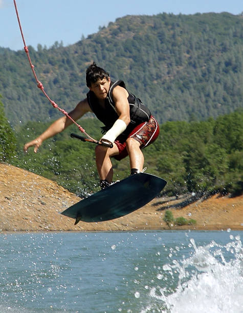 volare basso - life jacket little boys lake jumping foto e immagini stock