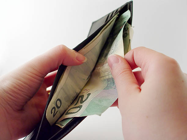 Pulling Money out of Wallet stock photo