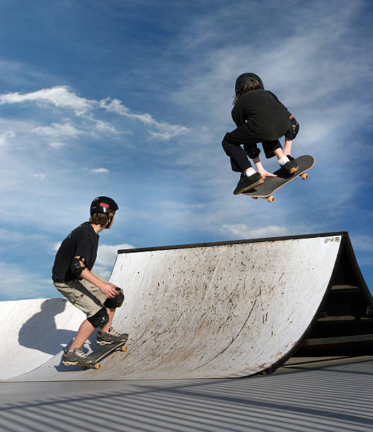 Young women skateboarding in skatepark