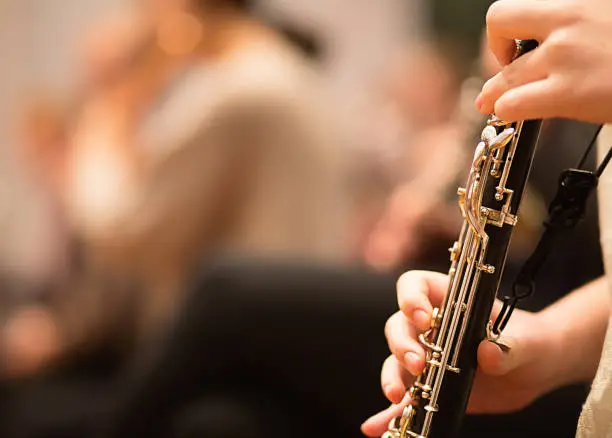 Oboe player performing in a symphony orchestra