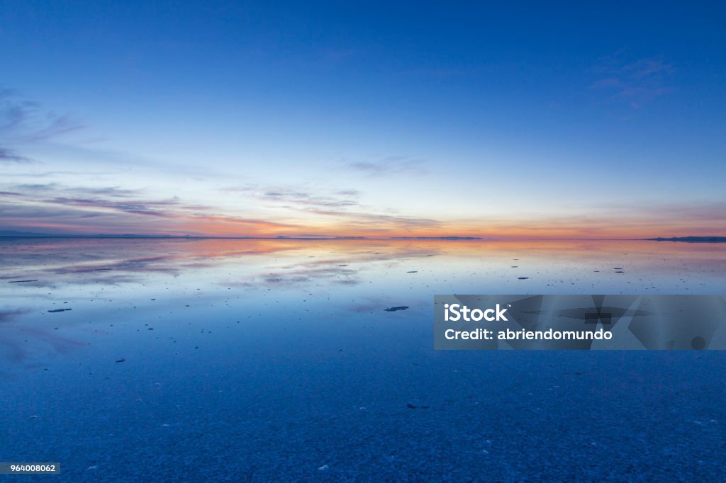 Uyuni reflections, an infinite horizon Uyuni reflections are one of the most amazing things that a photographer can see. Here we can see how the sunrise over an infinite horizon with the Uyuni salt flats making a wonderful mirror. Mirror - Object Stock Photo