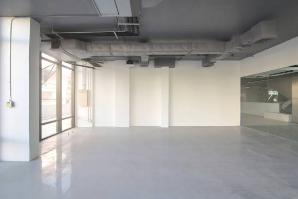 istock Empty office room on modern building with sunlight and indoor ventilation system on hight ceiling of large building 964008106
