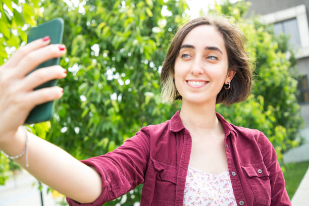 istock Young woman taking selfie 964010526