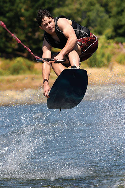 wakeboarding - life jacket little boys lake jumping foto e immagini stock