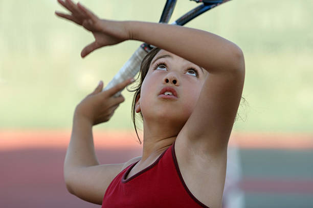 Young girl concentration while waiting for the tennis ball stock photo