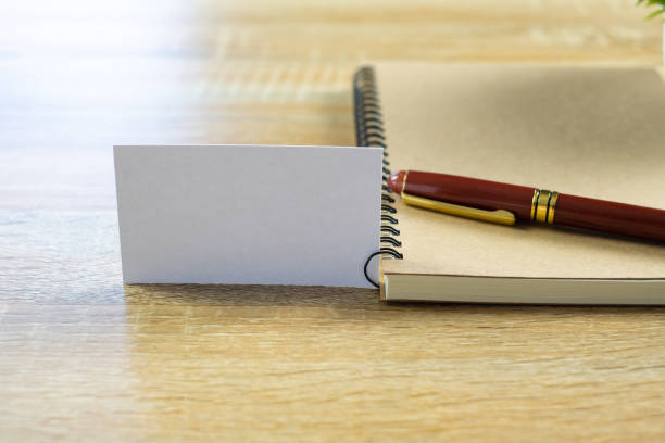 istock Blank business card or name card with space for add text name address and logo with notebook organizer on working table, financial company concept. 964013086
