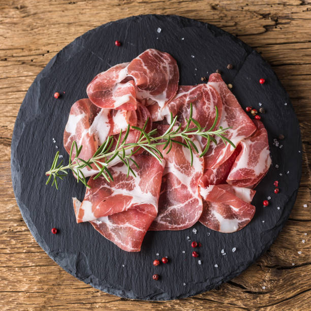 istock Coppa di Parma ham on slate board with rosemary salt and pepper 964016082