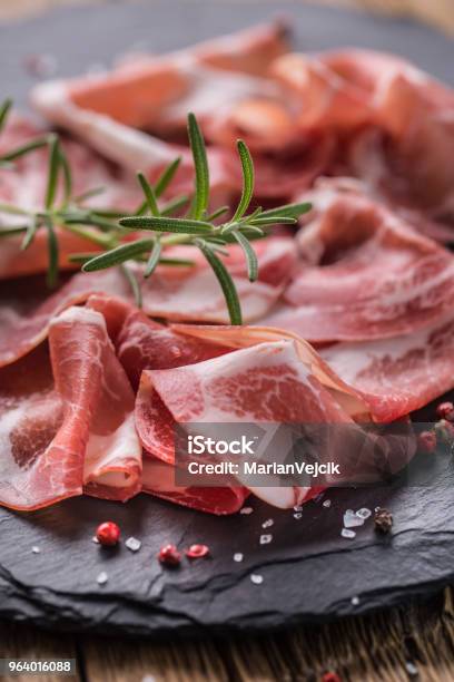 Coppa Di Parma Ham On Slate Board With Rosemary Salt And Pepper Stock Photo - Download Image Now