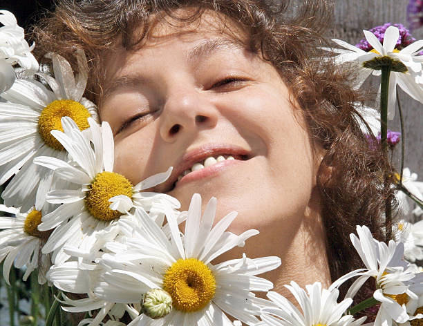istock Smiling woman with daisies 96402118