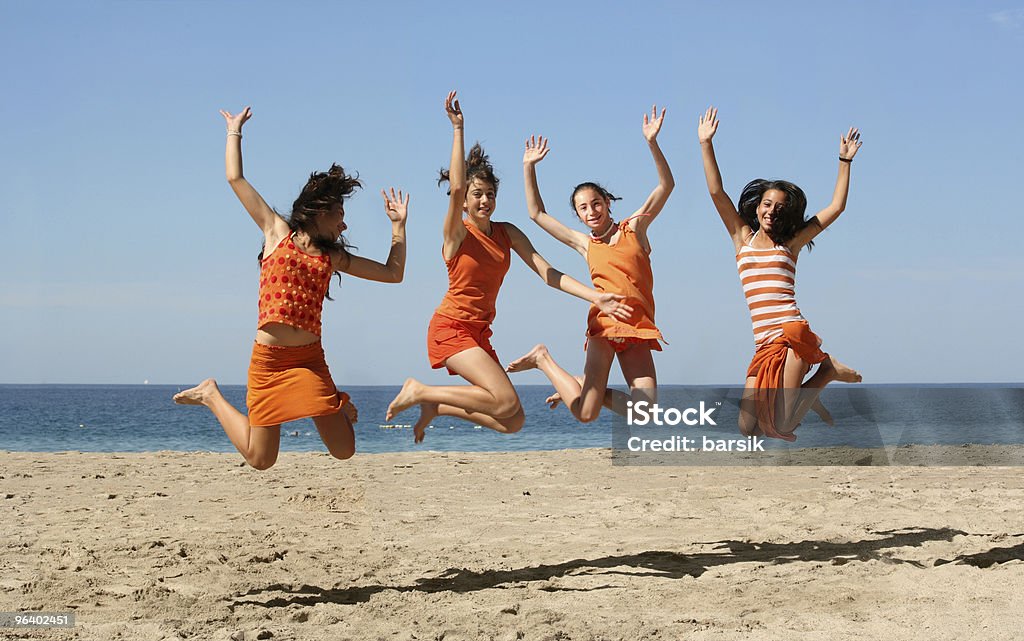 Four girls jumping  Beach Stock Photo