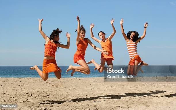 Four Girls Jumping Stock Photo - Download Image Now - Beach, Beach Party, Blue