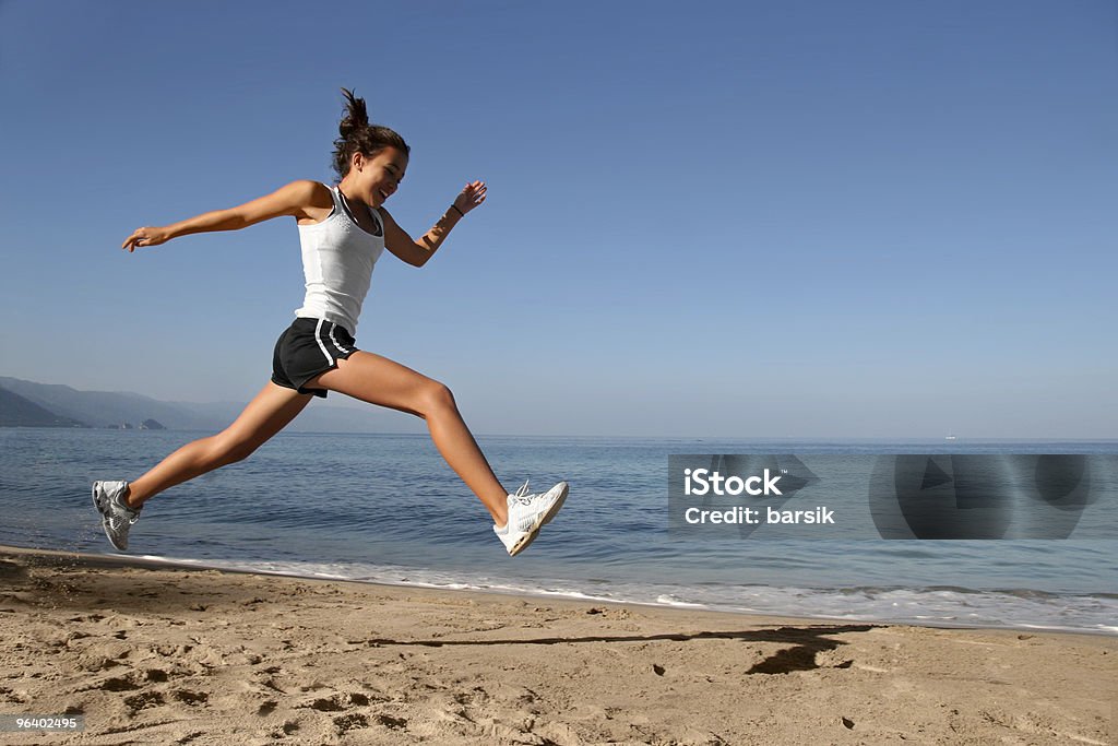 Jumping on the beach  Running Stock Photo