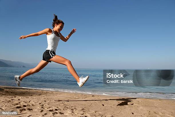 Jumping On The Beach Stock Photo - Download Image Now - Running, Adolescence, Adult