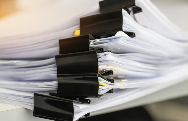 istock Stack of Paper documents with clip, Pile of unfinished documents on office desk folders. Business papers for Annual Report files, Document is written,presented. Business offices concept. 964028886