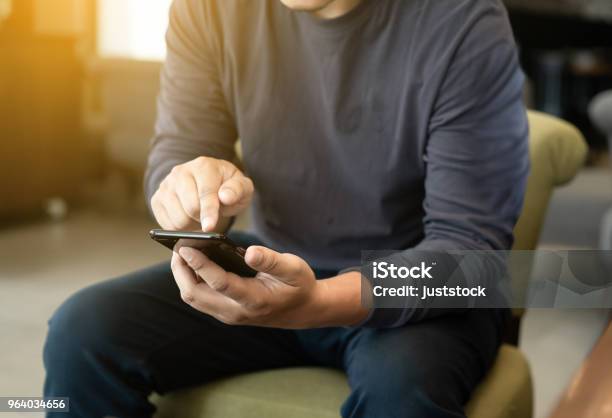 Foto de Homem Usando Telefone Inteligente Na E Ler A Mensagem Na Cafeteria e mais fotos de stock de Homens