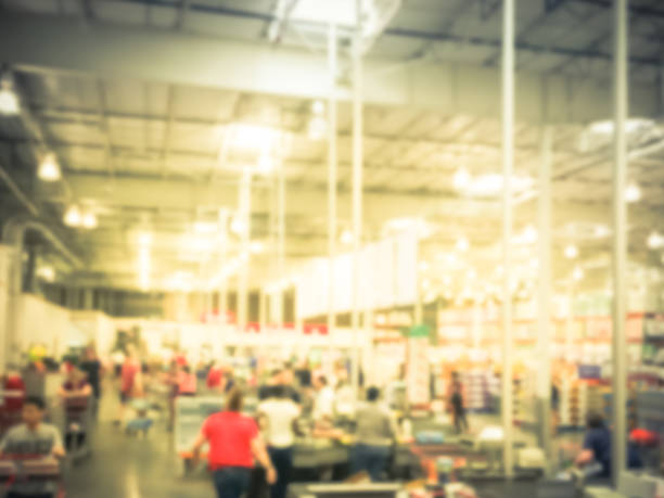 istock Vintage blurred long queue at checkout counter of wholesale store 964034732