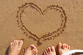 砂の背景に心愛のビーチのカップル。夏、幸せな週末のコンセプトです。