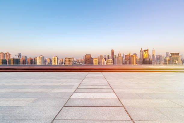 istock empty brick floor with skyline and buildings in sunrise 964037098