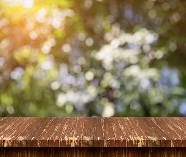 istock Empty wood table top with Green nature background.For product display 964045554