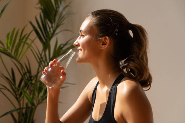 istock athletic female drinking water after gym 964053244