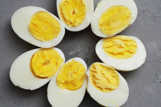 istock Hard Half Boiled Eggs, Sliced in Halves Food Ingredient Preparation Gray Textured Background 964064874