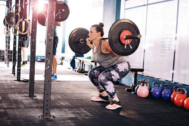 istock Overweight woman exercising in gym 964071210