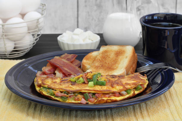 istock Western Omelet breakfast with toast and bacon.  Selective focus on omelet. 964076778