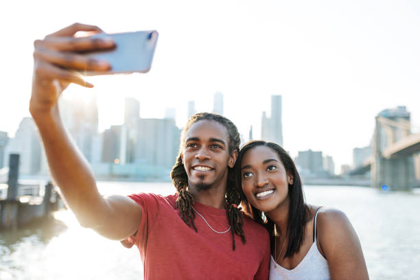 istock Young couple taking selfie near Brooklyn bridge 964077004