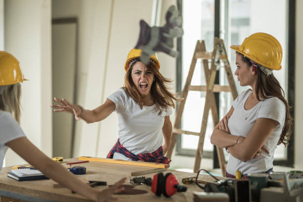 istock Frustrated female worker having problems with her coworkers at construction site. 964085630