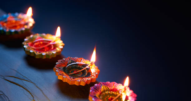 istock Happy Diwali - Diya lamps lit during celebration 964087812