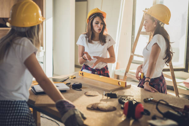 istock Team of female construction workers talking during home renovation process. 964087856