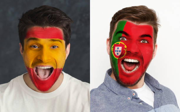 istock Emotional soccer fans with painted flags on faces 964088348