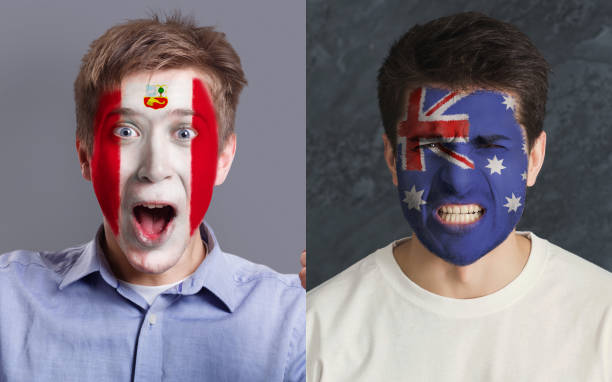 istock Emotional soccer fans with painted flags on faces 964088388
