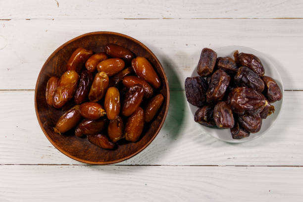 istock Dried dates fruit on white wooden table. Top view 964088410