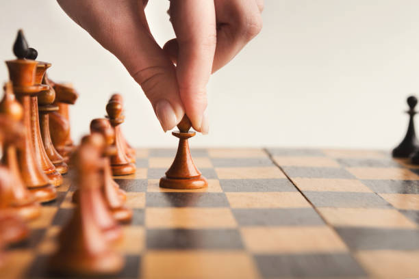 istock Hand of player chess board game putting white pawn 964091784