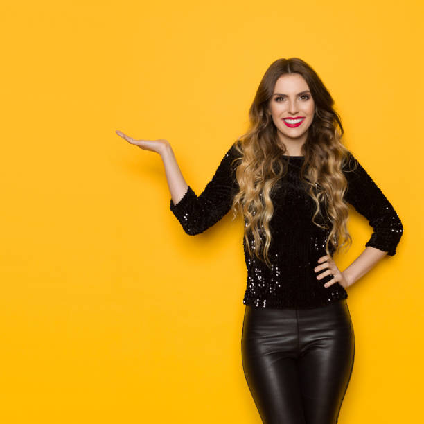 istock Beautiful Woman In Black Sequin Sweater Is Presenting And Smiling 964097970