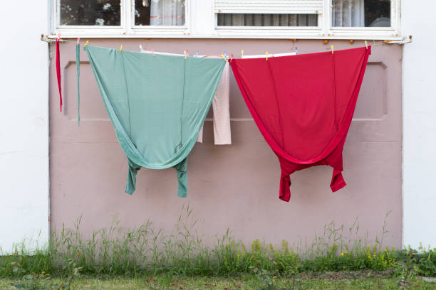 istock Dried laundry hanging on line. Red and green clothes. 964099058