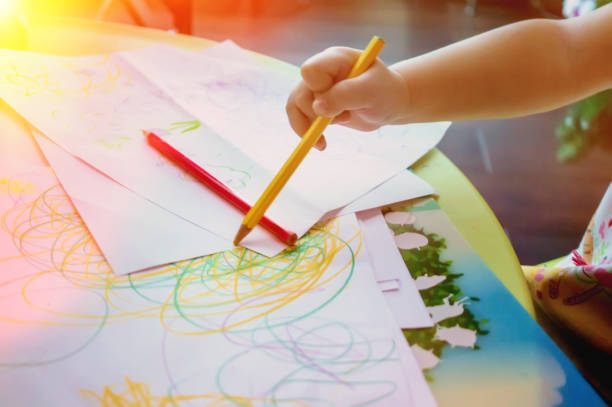 istock Close-up of a small child draws colored pencils 964101744