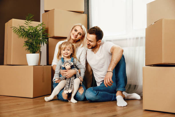 istock Smiling People With Kid Moving In New House 964119480