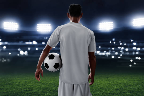 istock Soccer player holding soccer ball 964120032