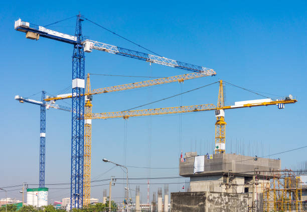 istock Group of high tower cranes in workplace 964120082