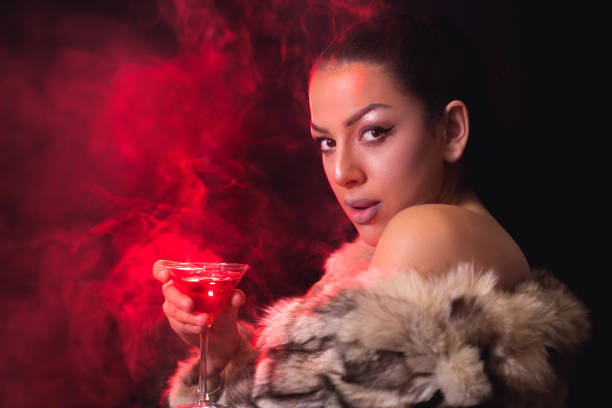 istock Brunette in fur coat with cocktail 964120098