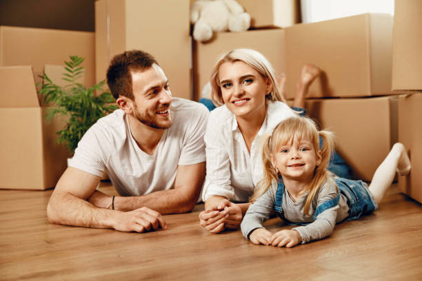 istock Smiling People With Kid Moving In New House 964122718