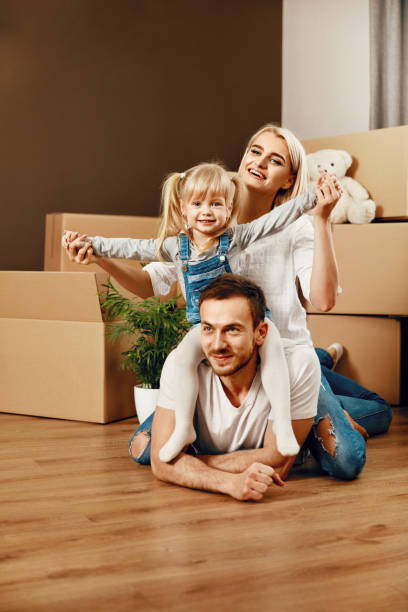 istock Smiling People With Kid Moving In New House 964122886