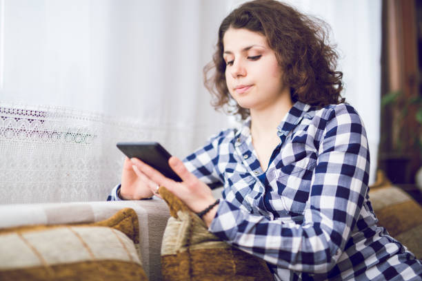 istock Young woman relaxing indoor and using tablet. 964123060