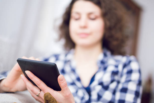 istock Young woman relaxing indoor and using tablet. 964123332