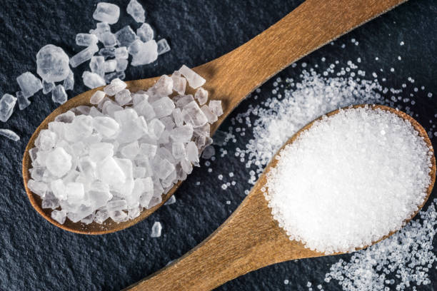 istock Different types of salt. Top view on two wooden spoons 964126678