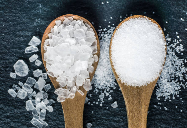istock Different types of salt. Top view on two wooden spoons 964126874