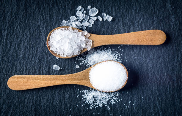 istock Different types of salt. Top view on two wooden spoons 964129226